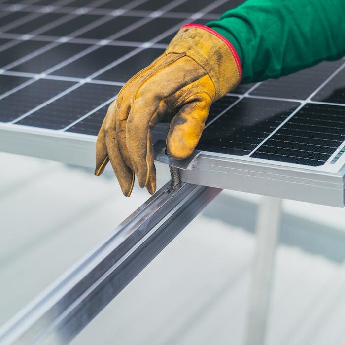 Person's Hand on Top of Solar Panel